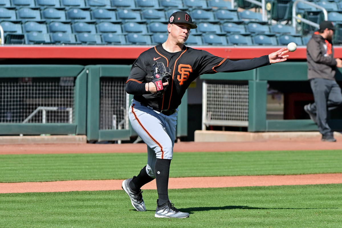 SF Giants pitcher Kyle Harrison throws to first base during a drill at spring training. (2023)